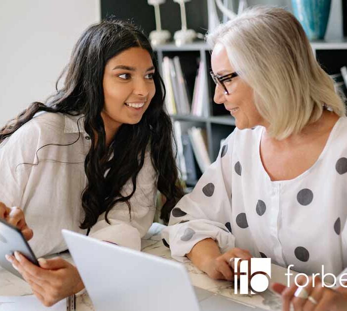 two women discussing business productivity and efficiency