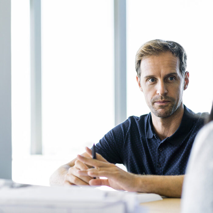 Business colleagues discussing at table in office