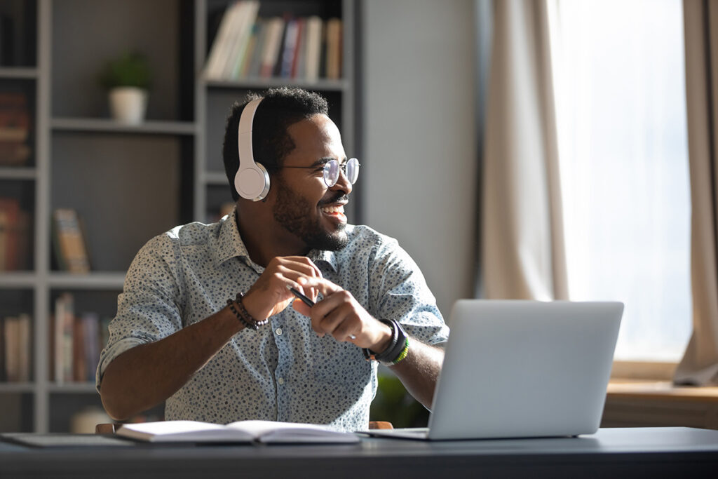 business man with headphones on laughing