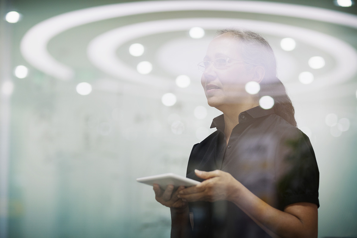 Senior Woman in a meeting with a tablet