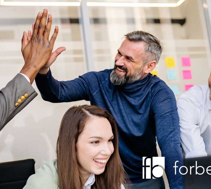 happy colleagues working together and promotes a healthy company culture