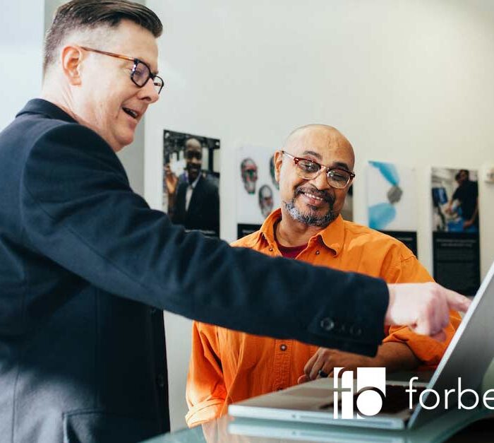 cheap liquidation man looking at laptop