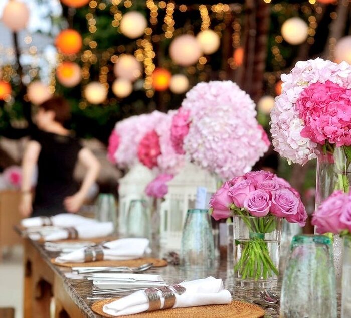 Pink flowers on long dinner table