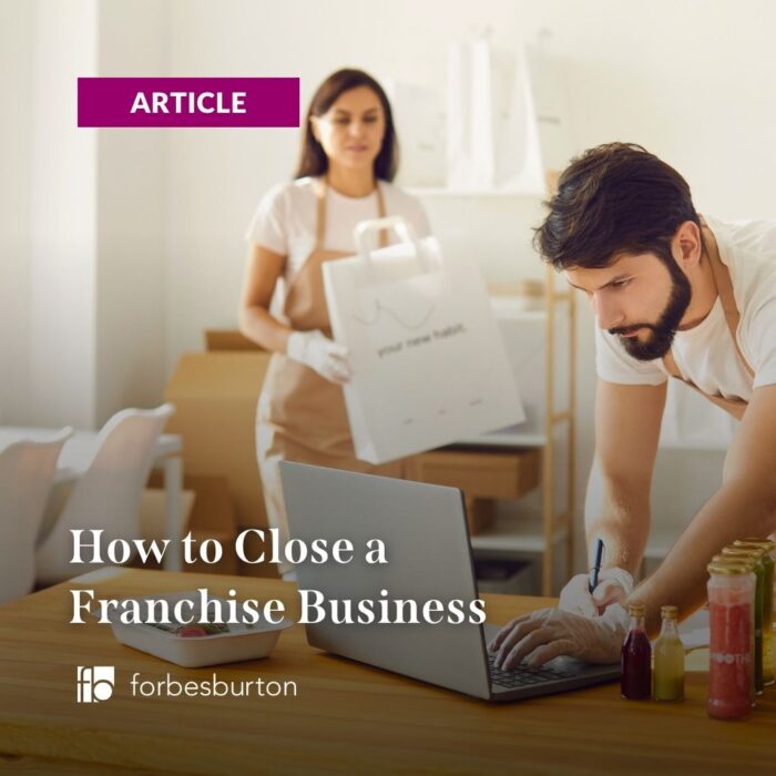 people trying to close a franchise business on their laptop