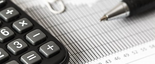 keep business finances in order calculator and pen