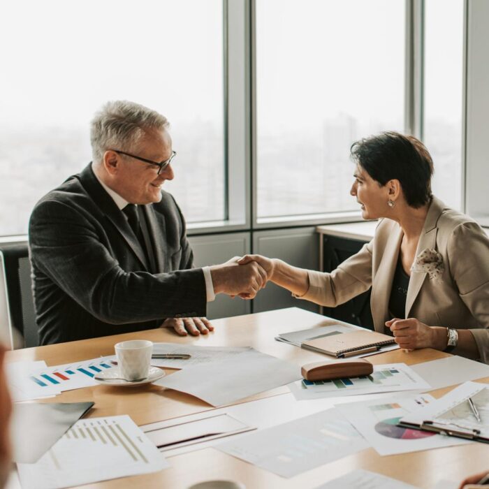 business exit planning culminating in a handshake over some charts