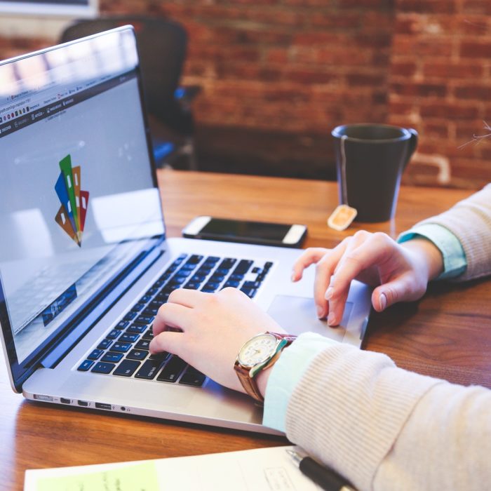 Business Person Typing on Laptop