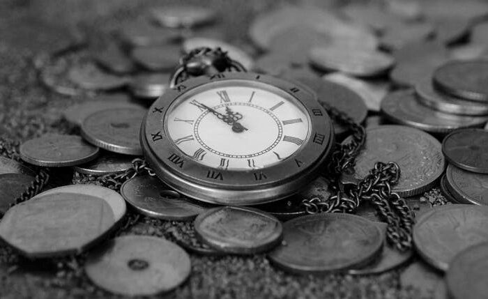 Black and white clock and pennies